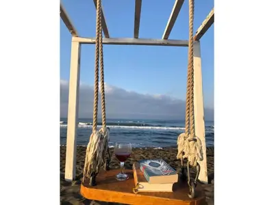 a table with a glass of wine and a book at Perla Luxury in Ulcinj