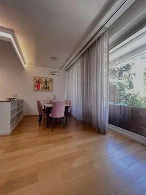 a dining room with a table and a large window at Dukley Retreat, Serenity Collection in Budva