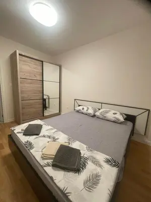 a bedroom with a bed with two towels on it at Alex 2210 in Podgorica