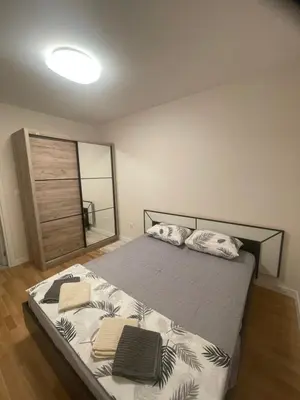 a bedroom with a bed with two towels on it at Alex 2210 in Podgorica