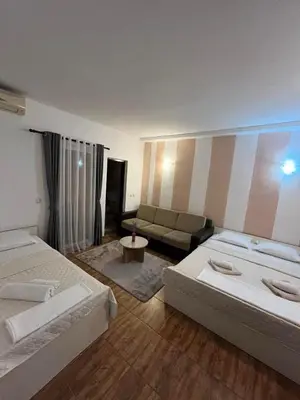 a living room with two beds and a couch at Pansion Aksa in Ulcinj