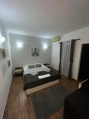 a bedroom with a large bed in a room at Pansion Aksa in Ulcinj