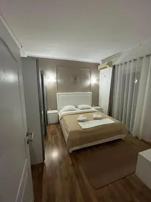 a bedroom with a large bed in a room at Pansion Aksa in Ulcinj