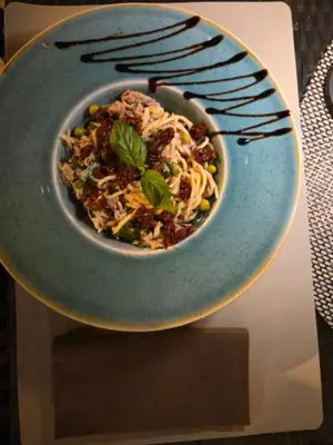 a bowl of food on a plate on a table at Pansion Aksa in Ulcinj