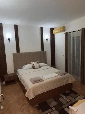 a bedroom with a bed with two towels on it at Pansion Aksa in Ulcinj