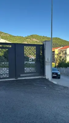 a garage door with a gate on a street at Georgijevic 2 in Budva