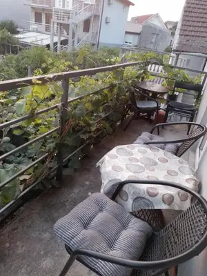 a balcony with chairs and a table on a balcony at Nada Apartman in Lastva