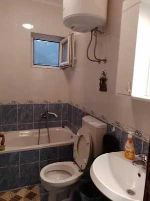 a bathroom with a toilet and a sink and a tub at Nada Apartman in Lastva