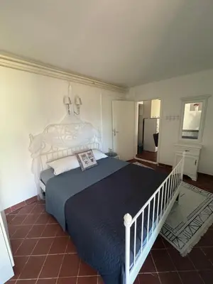 a bedroom with a large bed with a blue blanket at Luxury apartments Budva in Budva
