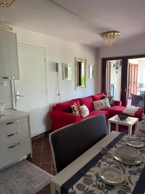 a living room with a red couch and a table at Luxury apartments Budva in Budva