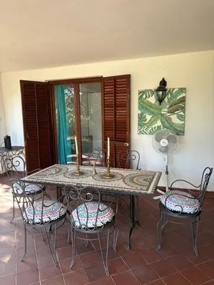 a dining room table with chairs and a painting on the wall at Luxury apartments Budva in Budva