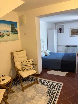 a bedroom with a bed and a chair and a table at Luxury apartments Budva in Budva