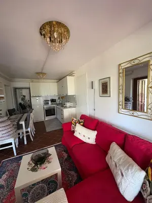 a living room with a red couch and a kitchen at Luxury apartments Budva in Budva