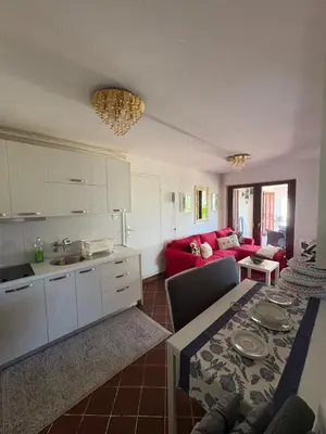 a kitchen and living room with a table and a couch at Luxury apartments Budva in Budva