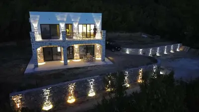 an aerial view of a house at night with lights at Maginja in Petrovac na Moru