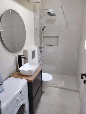 a bathroom with a sink and a washing machine at Maginja in Petrovac na Moru