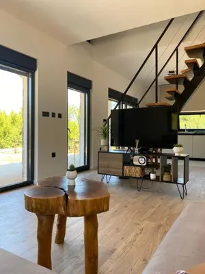 a living room with a table and a tv at Maginja in Petrovac na Moru