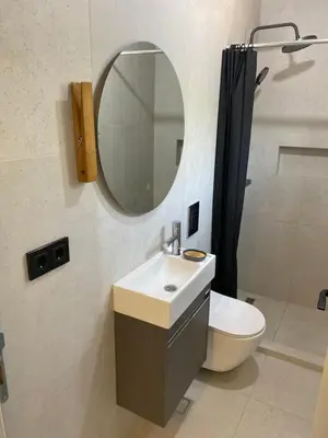 a bathroom with a sink and a mirror and a toilet at Maginja in Petrovac na Moru
