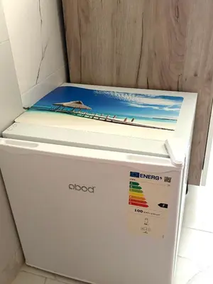 a white refrigerator with a surfboard on top of it at Nina apartman in Budva