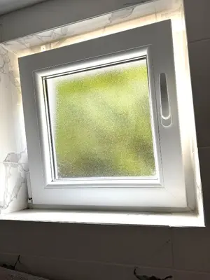 a window in a bathroom with a window sill at Nina apartman in Budva