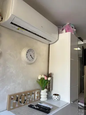 a kitchen with a clock on the wall and a table at Nina apartman in Budva