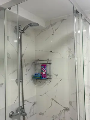 a bathroom with a shower with a glass door at Nina apartman in Budva