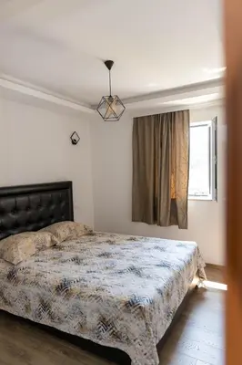a bedroom with a large bed and a window at Apartments Ceka in Ulcinj