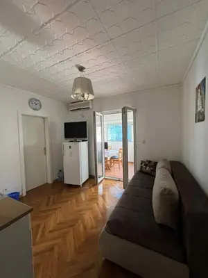 a living room with a couch in the middle of it at Marko's place in Budva