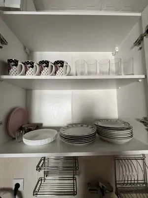 a kitchen with plates and cups and dishes on shelves at Marko's place in Budva