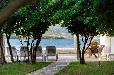 a group of chairs sitting next to a body of water at Vila PETICA in Tivat