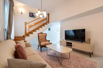 a living room with a couch and a tv at Vila PETICA in Tivat