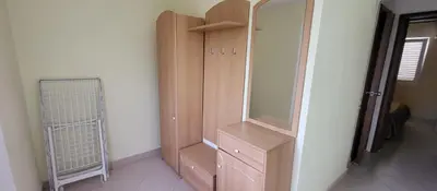 a wooden cabinet in a room with a mirror at UGS Apartment in Sutomore