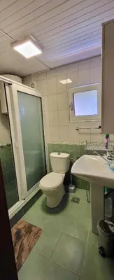 a bathroom with a toilet and a sink at UGS Apartment in Sutomore