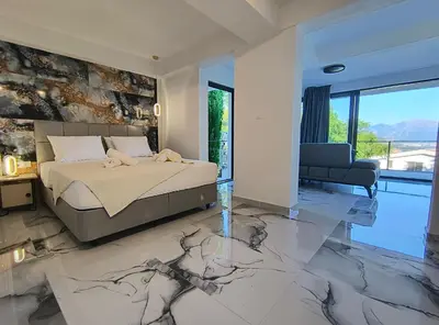 a bedroom with a bed with a marble floor at Villa vista mare in Zagrađe