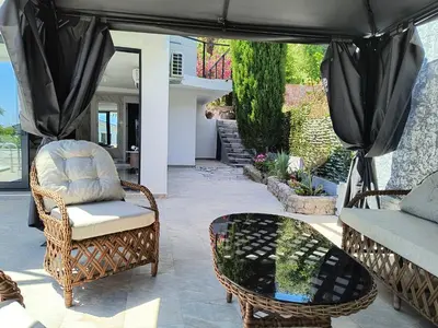 a patio with chairs and a table and a couch at Villa vista mare in Zagrađe