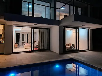 a house with a swimming pool at night at Villa vista mare in Zagrađe