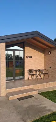 a patio with tables and benches on a building at Rural stay Miranovic in Balabani