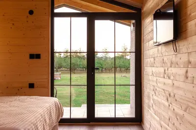 a bedroom with a bed and a large window at Rural stay Miranovic in Balabani