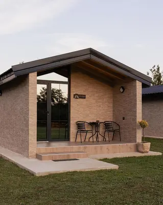 a building with a table and chairs in it at Rural stay Miranovic in Balabani