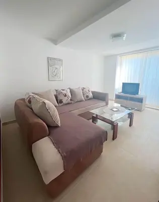 a living room with a couch and a coffee table at Villa INA in Kaluđerac