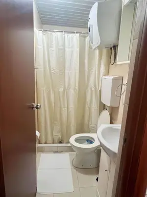 a small bathroom with a toilet and a sink at Villa INA in Kaluđerac
