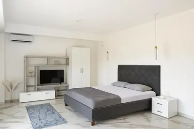 a bedroom with a bed and a flat screen tv at Alfredo in Ulcinj