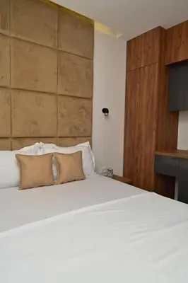 a bedroom with a white bed with two pillows at Stars Five Apartments in Ulcinj