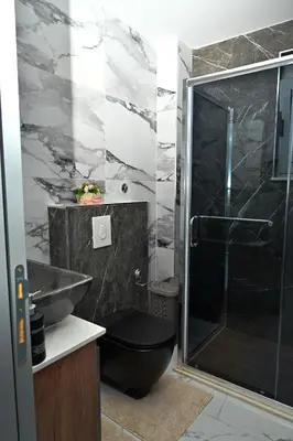 a bathroom with a shower and a toilet and a sink at Stars Five Apartments in Ulcinj