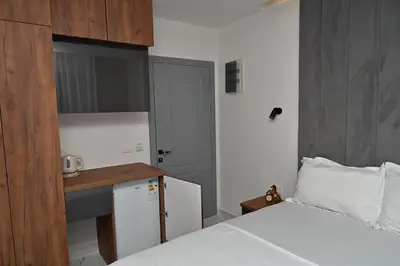 a small bedroom with a bed and a small kitchen at Stars Five Apartments in Ulcinj