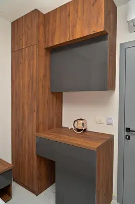 a kitchen with wooden cabinets and a wooden counter top at Stars Five Apartments in Ulcinj
