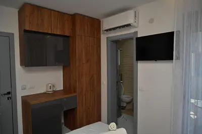 a room with a bathroom with a tv and a toilet at Stars Five Apartments in Ulcinj