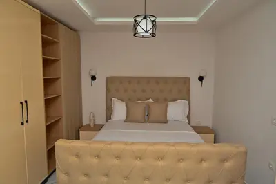 a bedroom with a large bed with a large headboard at Stars Five Stay in Ulcinj