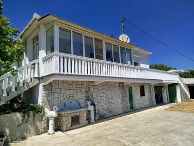 a large house with a balcony on top of it at Kuća Duskic in Kunje