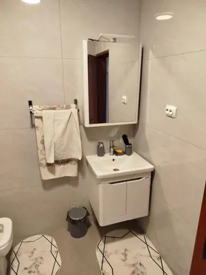 a bathroom with a sink and a mirror and a toilet at Kuća Duskic in Kunje
